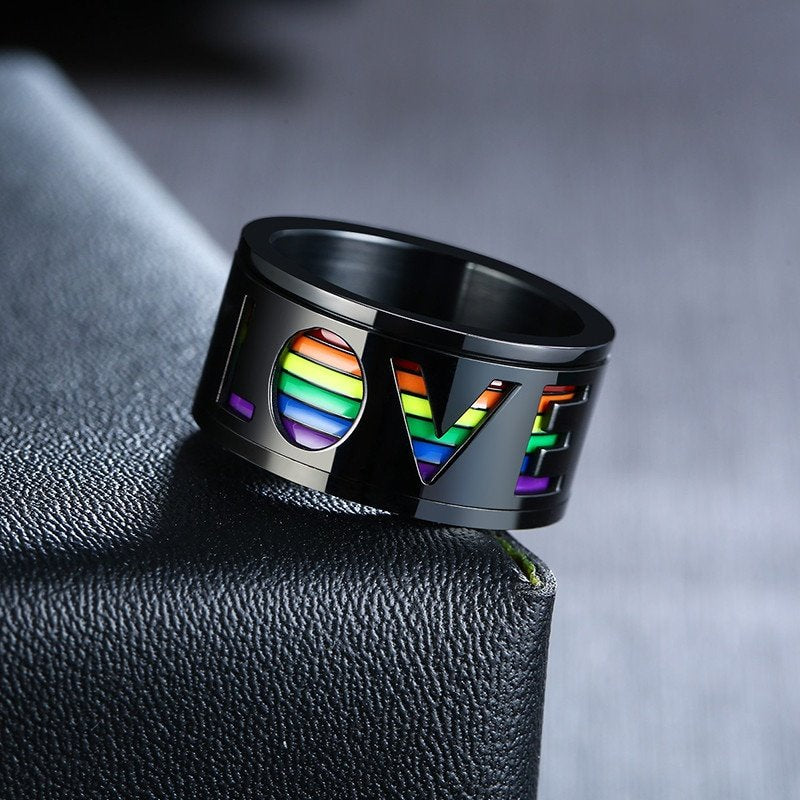 Superbe bague noire avec l'inscription Love sur fond de couleurs arc-en-ciel